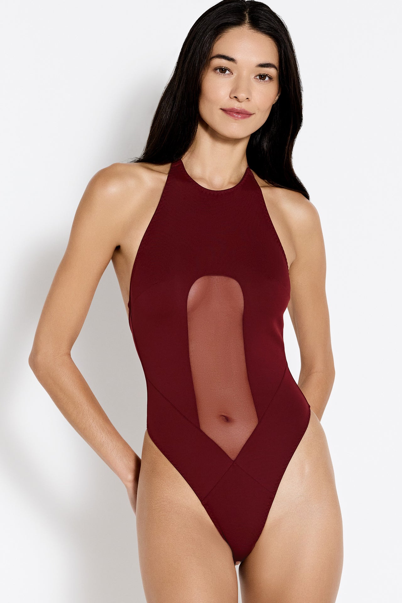 Bordelle Syra halter bodysuit with mesh front & high leg in burgundy morello. Front view on model.