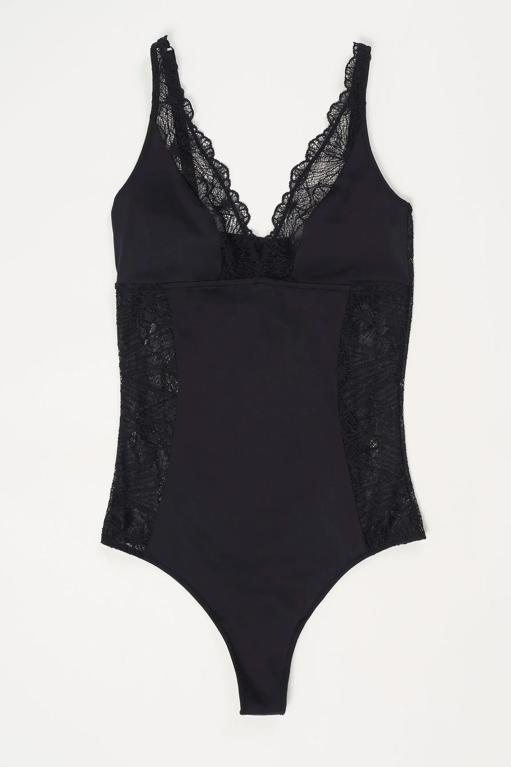 Else Daphne bodysuit in black, front view, shown flat on white background. Opaque microfiber wireless cups and body with sheer lace trim on plunge neckline and torso sides. High apex triangle plunge cups.