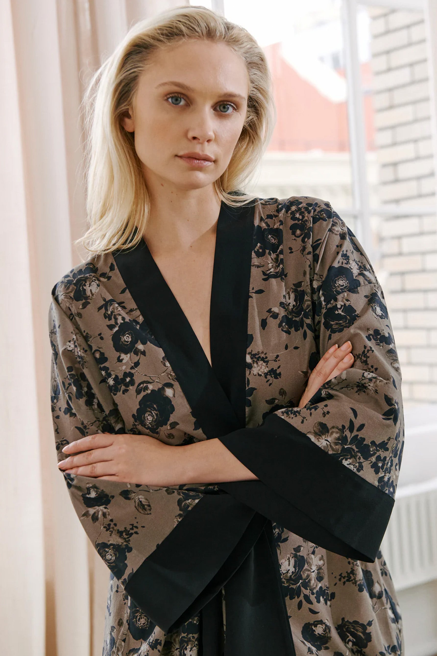 Else Euphoria taupe robe with black floral print and black silk trim. Image shows the robe on model, front view, featuring the wide kimono style sleeves.