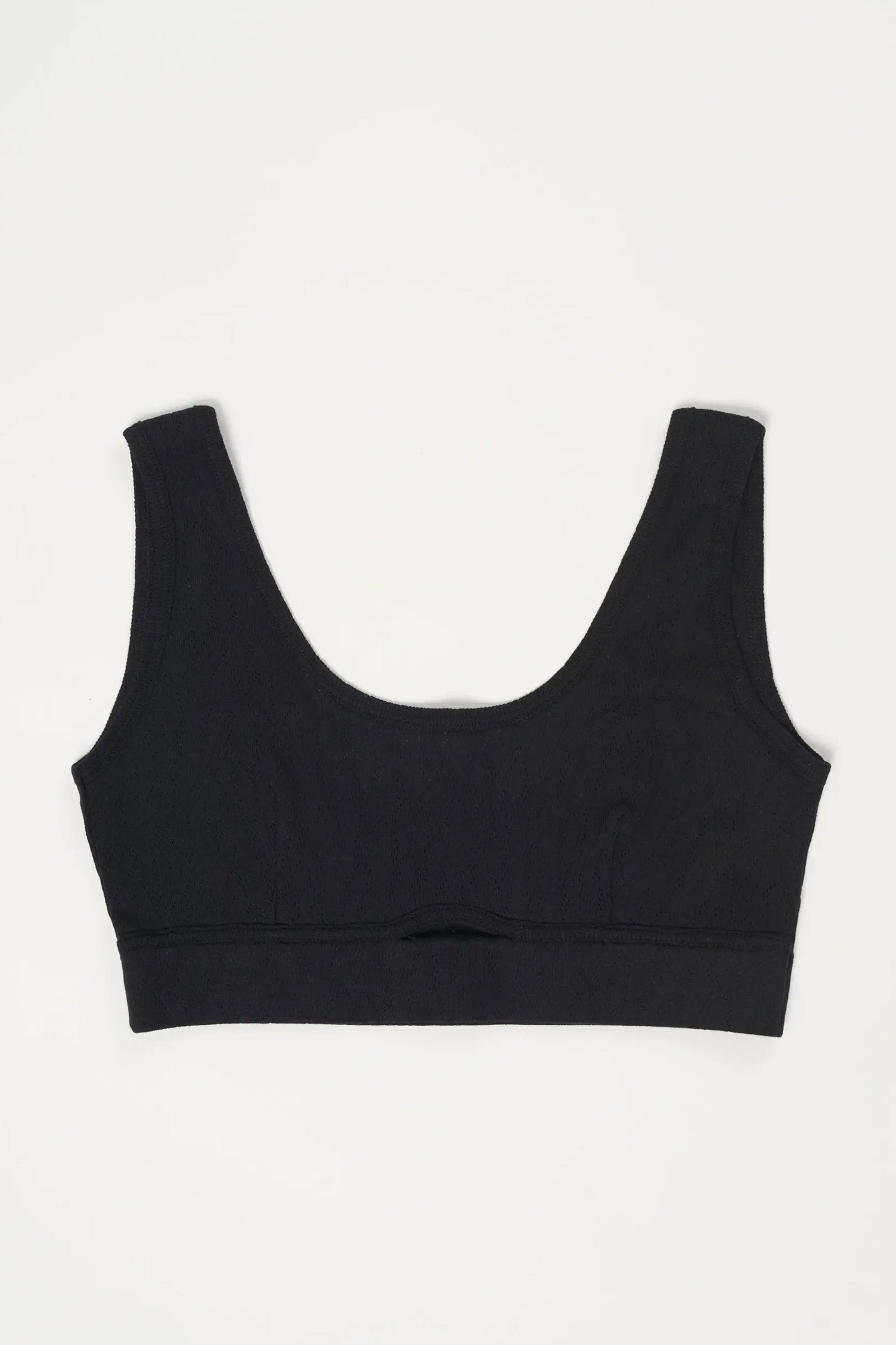 Else Pointelle bralette in black, front view flat on white background. Image shows tank style bralette in pointelle cotton, with wide shoulder straps and cutout at center front. 