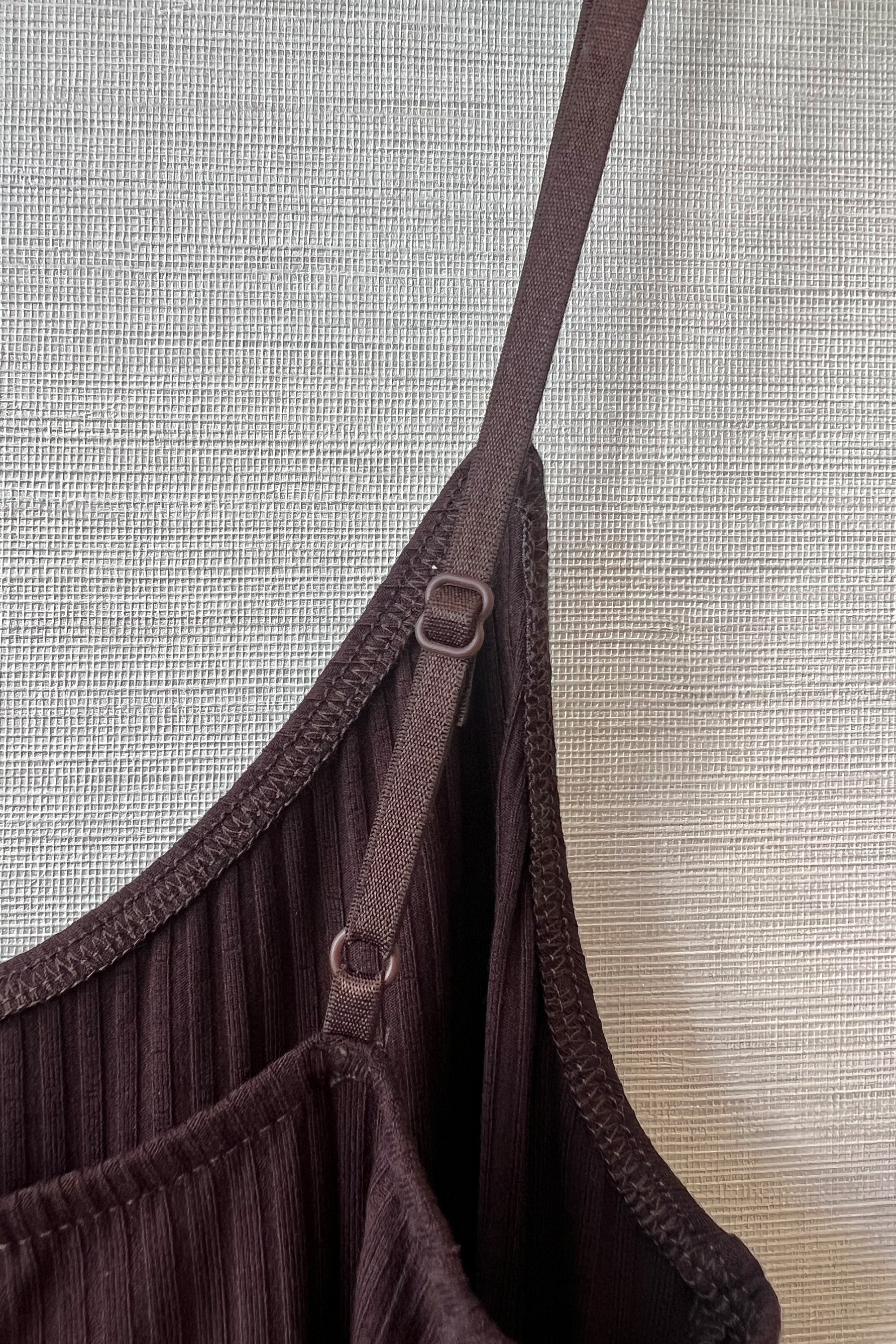 Close up of Only Hearts Eco Rib slip dress, showing interior surged stitching, adjustable elastic shoulder straps, and ribbed knit. 