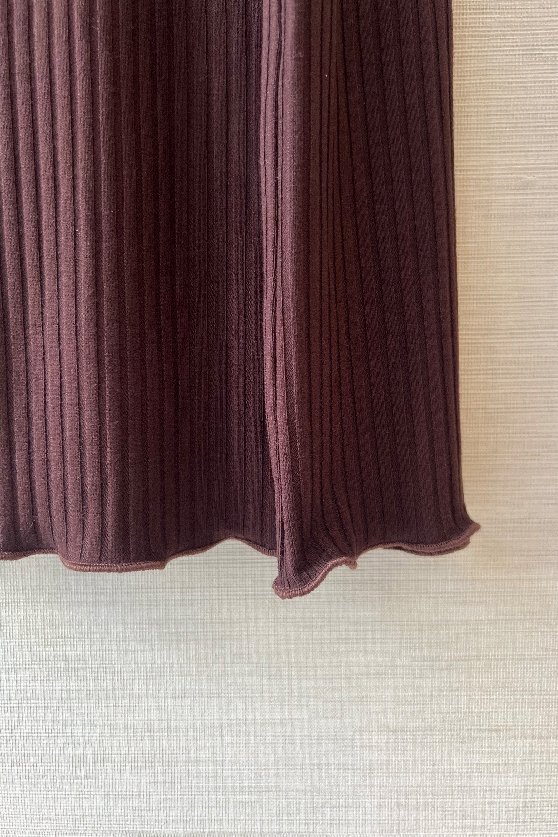 Close up of Only Hearts Eco Rib slip dress in dark brown caffeine, showing ribbed knit and lettuce edge hemline. 