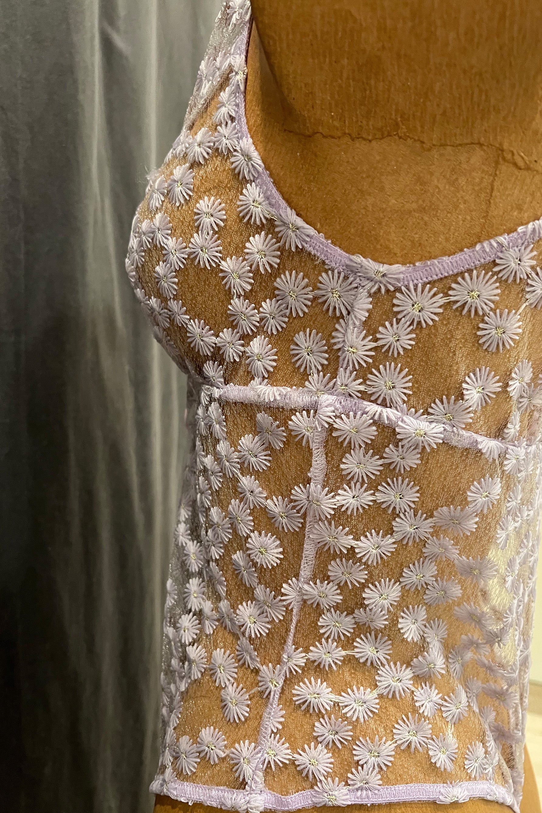 Only Hearts Isabel Bonbon daisy embroidered sheer bodysuit in lilac, close up side view.