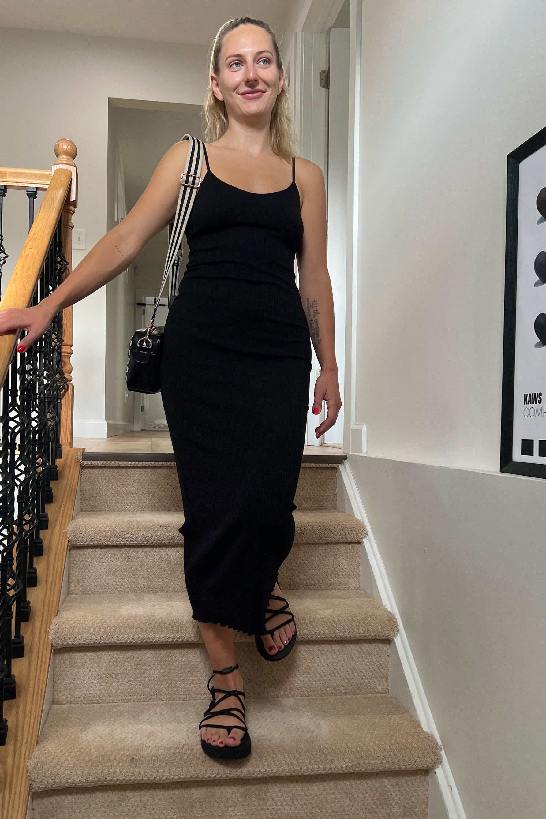 Only Hearts Eco Rib slip dress in black, front view on model. Image shows midi length lettuce edge hem, spaghetti straps, and clingy silhouette. 