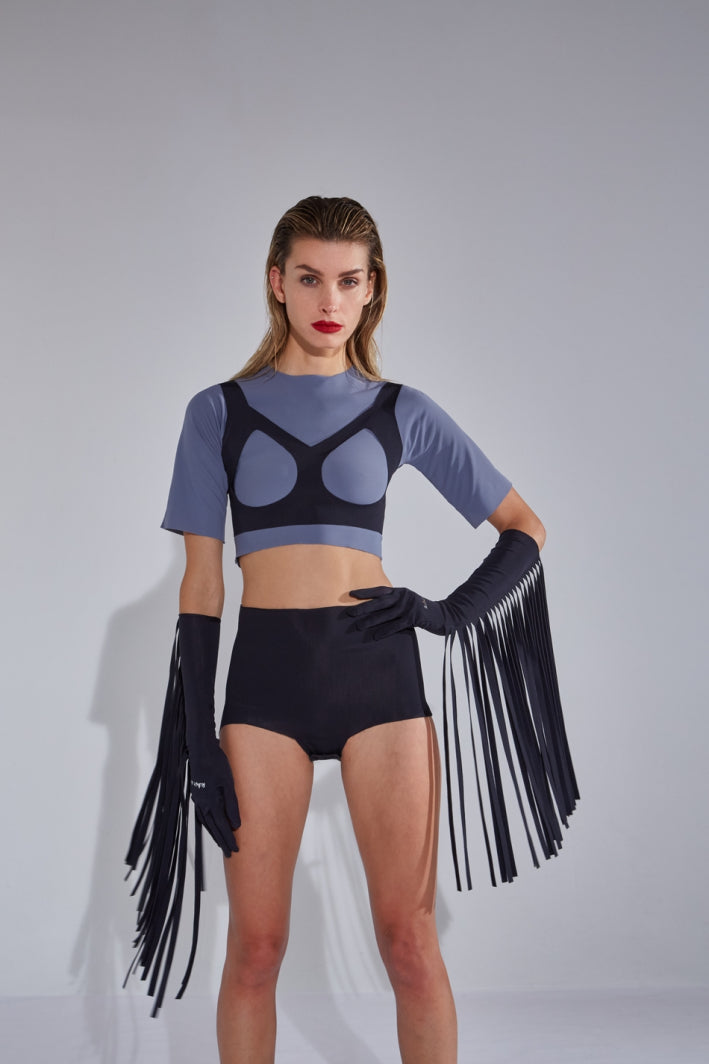 Ruban Noir black elbow gloves with long fringe. Shown on model in gray blue crop top with open cup bra, and black shorts/briefs.