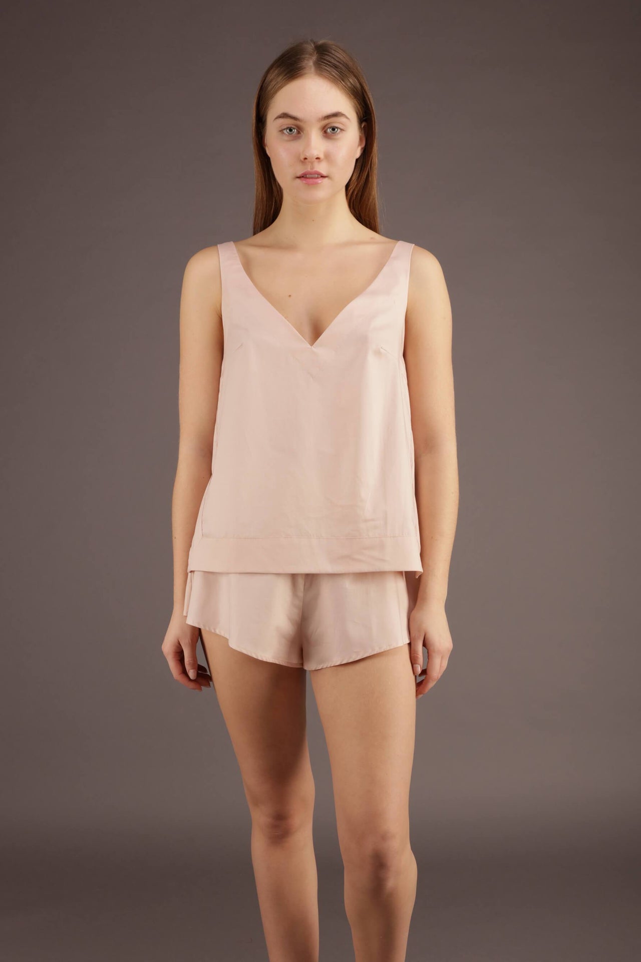 Blush pink cotton v-neck cotton camisole, front view on model.